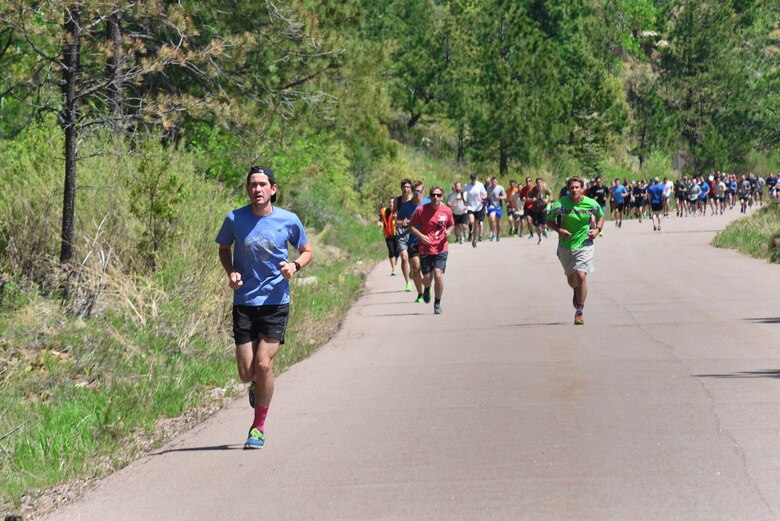 Runners race up the mountain at the Cheyenne Mountain Air Force Station 5k Tunnel Run/Open House at Cheyenne Mountain Air Force Station, Colo., on May 26, 2016. Participants had the opportunity to pause along the route, to experience the blast doors and information and historical booths. (U.S. Air Force photo by Airman 1st Class Dennis Hoffman)