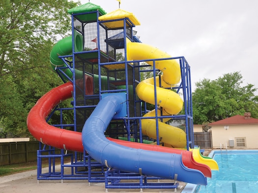 The Barksdale Air Force Base, La., pool's four waterslides tower over the water, standing by to be enjoyed by children all summer. The pool offers lap swim, free swim, swim lessons, a kiddie pool and a snack bar. (Courtesy photo)
