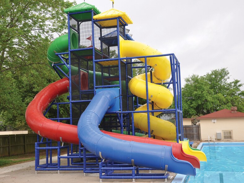 The Barksdale Air Force Base, La., pool's four waterslides tower over the water, standing by to be enjoyed by children all summer. The pool offers lap swim, free swim, swim lessons, a kiddie pool and a snack bar. (Courtesy photo)