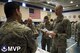 Master Sgt. Peter Jason Uson (left), Airman and Family Readiness NCO in charge, talk to Capt. Eric Miller, 2nd Space Operations Squadron, about his organization during a Space Mission Force transition event at Schriever Air Force Base, Colorado, May 26, 2016. In the same mold as a deployment in-processing briefing, the transition event was designed to provide information to Airmen entering their combat rotation about various helping agencies on base. These organizations include the chaplain, Airmen and Family Readiness Center, physiology, mental health, Family Advocacy, and Military and Family Life Counseling. (U.S. Air Force photo illustratio/Tech. Sgt. Julius Delos Reyes)