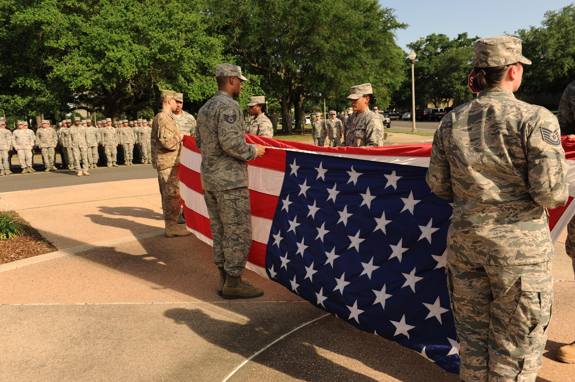 Members of the 334th Training Squadron fold the U.S. flag during the 81st Training Wing Memorial Day Retreat Ceremony May 26, 2016, Keesler Air Force Base, Miss. The ceremony was held in memory of Operation Desert Storm. Attendees were also encouraged to wear uniforms from their past deployments. (U.S. Air Force photo by Kemberly Groue)