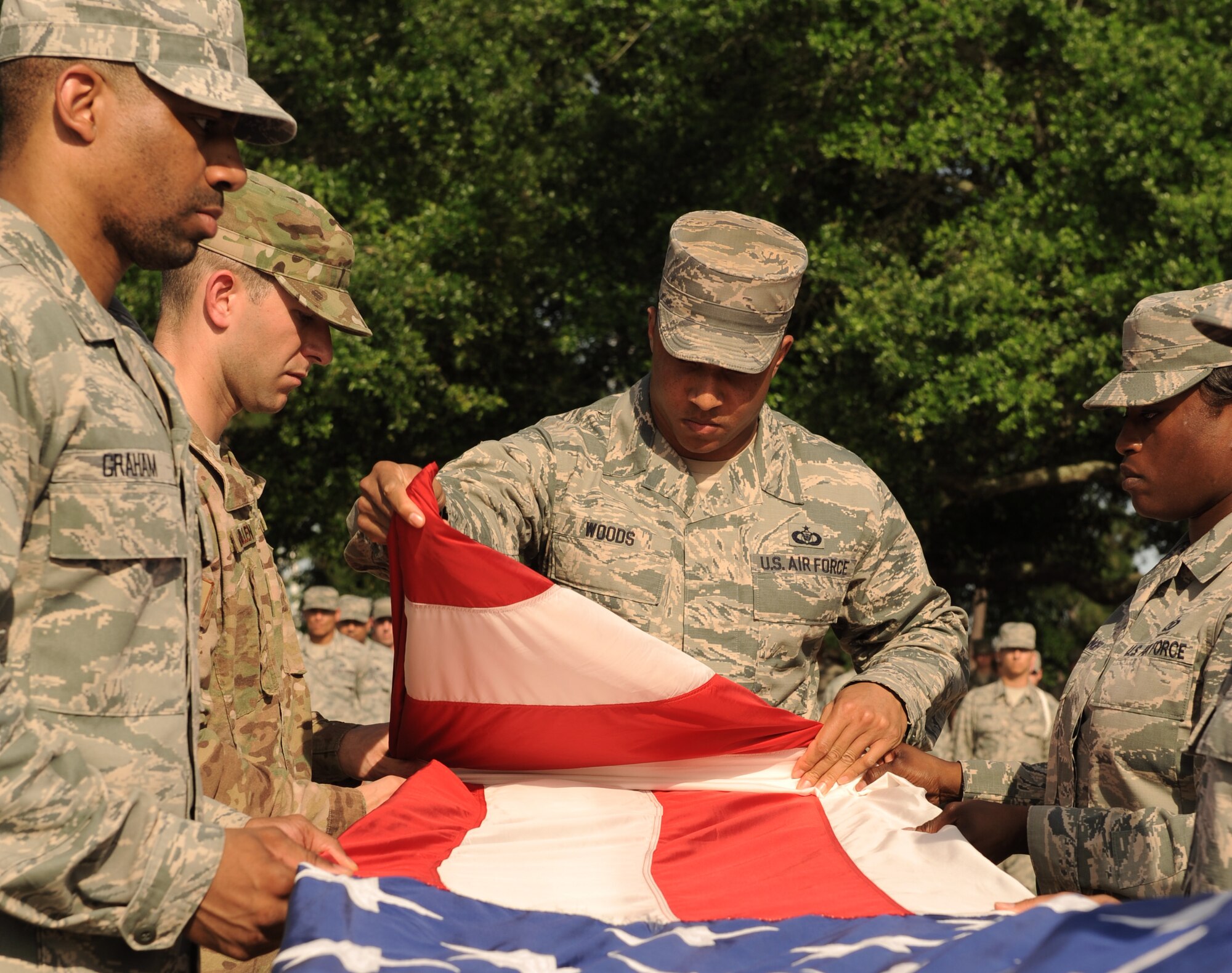 Members of the 334th Training Squadron fold the U.S. flag during the 81st Training Wing Memorial Day Retreat Ceremony May 26, 2016, Keesler Air Force Base, Miss. The ceremony was held in memory of Operation Desert Storm. (U.S. Air Force photo by Kemberly Groue)