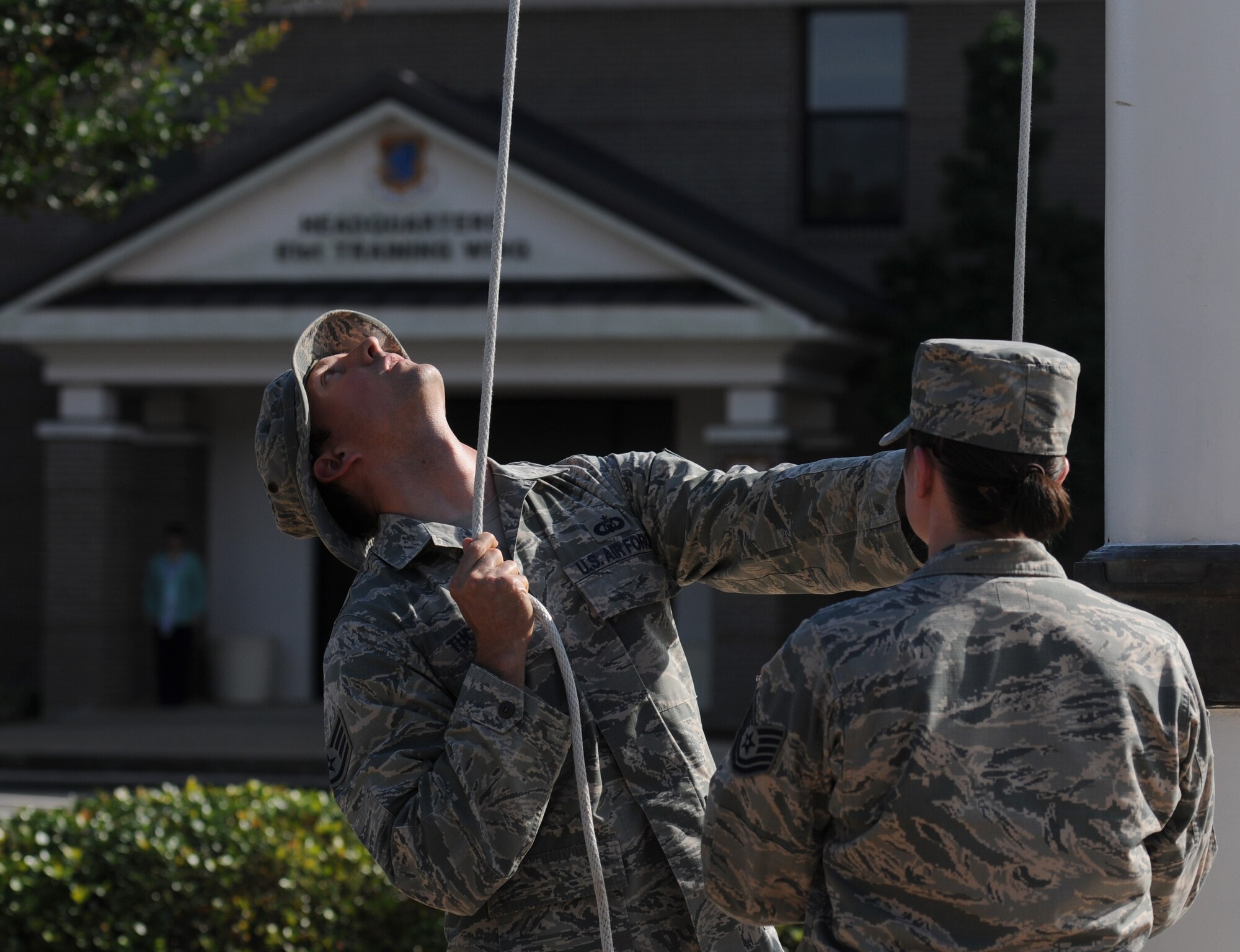 Staff Sgt. Jacob Tucker, 334th Training Squadron instructor, lowers the U.S. flag during the 81st Training Wing Memorial Day Retreat Ceremony May 26, 2016, Keesler Air Force Base, Miss. The ceremony was held in memory of Operation Desert Storm. Attendees were also encouraged to wear uniforms from their past deployments. (U.S. Air Force photo by Kemberly Groue)