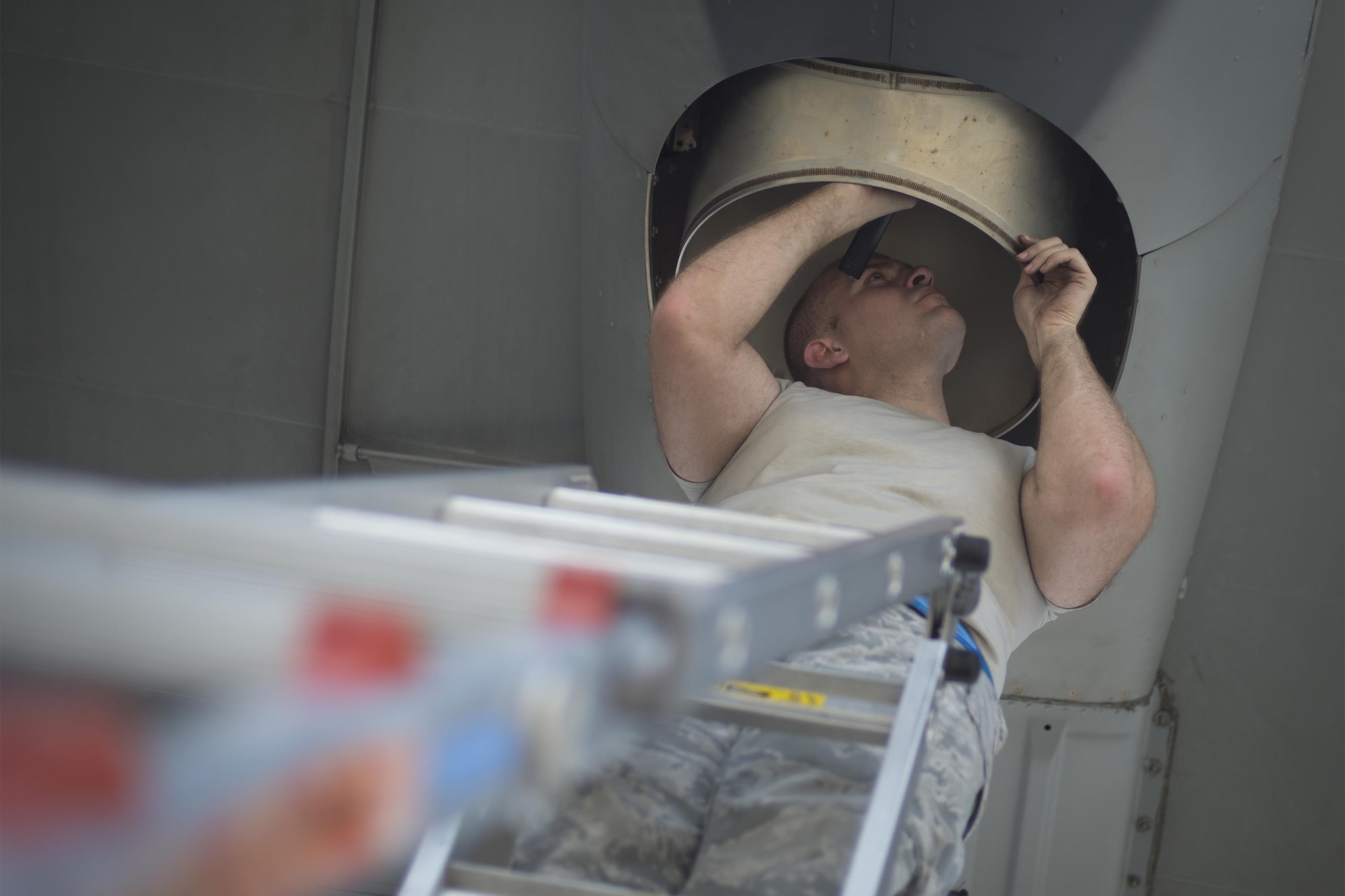 U.S. Air Force Senior Airman Ernesto Cruz, 23d Equipment Maintenance Squadron aerospace propulsion journeyman, checks exhaust ports on an HC-130J Combat King II during an isochronal inspection, May 31, 2016, at Moody Air Force Base, Ga. The HC-130J is a personnel recovery and combat search and rescue aircraft. (U.S. Air Force photo by Airman Daniel Snider/Released)