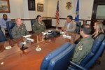 Dred Madison, 12th Flying Training Wing terminal instrument procedures chief, Lt. Col. Emil Bliss, 12th FTW community innitiatives chief, and Col. Michael Snell, 12th FTW commander, meet with Rep. John Lujan, Texas House of Representatives member, in the Wing Conference Room at bldg. 100 at Joint Base San Antonio-Randolph during an orientation tour, May 31, 2016. Lujan learned about compatible development, bird air strike hazards, and visited the air traffic control tower and flight simulator facility among. (U.S. Air Force photo by Randy Martin/Realsed)