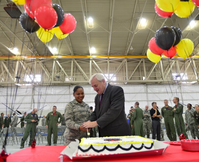 Airman Christier, 432nd Operations Support Squadron, left, and retired Lt. Gen. Robert Dierker, former 432nd Operations Group commander, cut a birthday cake during the 432nd OG 25th Anniversary celebration May 20, 2016, at Creech Air Force Base, Nevada. The men and women of the 432nd OG employ and train more than 1100 personnel in MQ-1 Predator and MQ-9 Reaper operations.  (U.S. Air Force photo by Senior Airman Christian Clausen/Released)