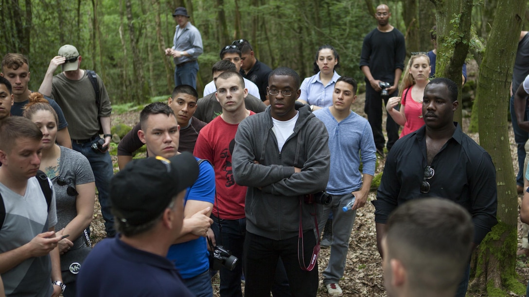 Marines listen to Mr. Ray Shearer, a Marine veteran and director and chairman of American Oversees Memorial Day Association, explain different factors in the Battle of Belleau Wood during World War I, on the battle ground Belleau, France, May 26, 2016. Marines observed trenches, depressions of fighting holes and enemy shelling on the battle ground. 
