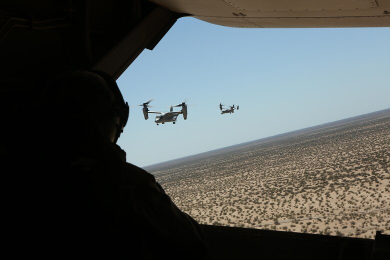 A Marine with Marine Medium Tiltrotor Squadron (VMM) 364 “Purple Foxes” checks the rear of an MV-22B Osprey during section and division confined area landings at Holtville Airfield, Calif., May 20. The training was conducted to familiarize both pilots and crew chiefs with landing in a small area around other aircraft. (U.S. Marine Corps photo by Pfc. Liah Kitchen/Released)