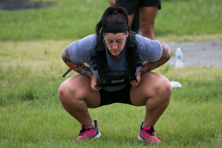 Army Sgt. Lauryn Lopez performs a squat while participating in the “Murph” Challenge for Memorial Day on Marine Corps Air Station Futenma, Okinawa, Japan. The “Murph” Challenge is a workout made to honor Lt. Michael “Murph” Murphy, a navy SEAL who died in Afghanistan June 28, 2005, at the age of 29. The challenge consists of a one-mile run, 100 pullups, 200 pushups, 300 squats, and another one-mile run, while wearing a 20 pound vest. Lopez is a military police officer with 247th Military Police Detachment, Okinawa, Japan. (Marine Corps Photo by Cpl. Douglas Simons/Released)