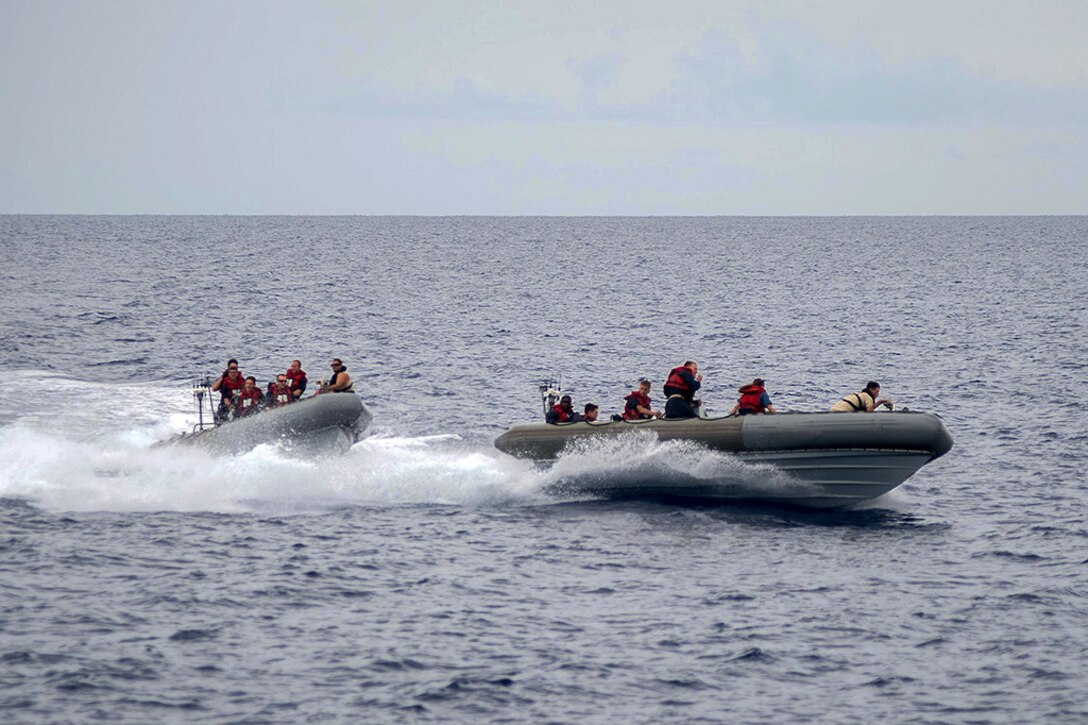 Two rigid-hull inflatable boat crews from the guided-missile cruiser USS Mobile Bay practice interception maneuvers during small boat operations in the South China Sea, May 31, 2016. Navy photo by Petty Officer 2nd Class Ryan J. Batchelder