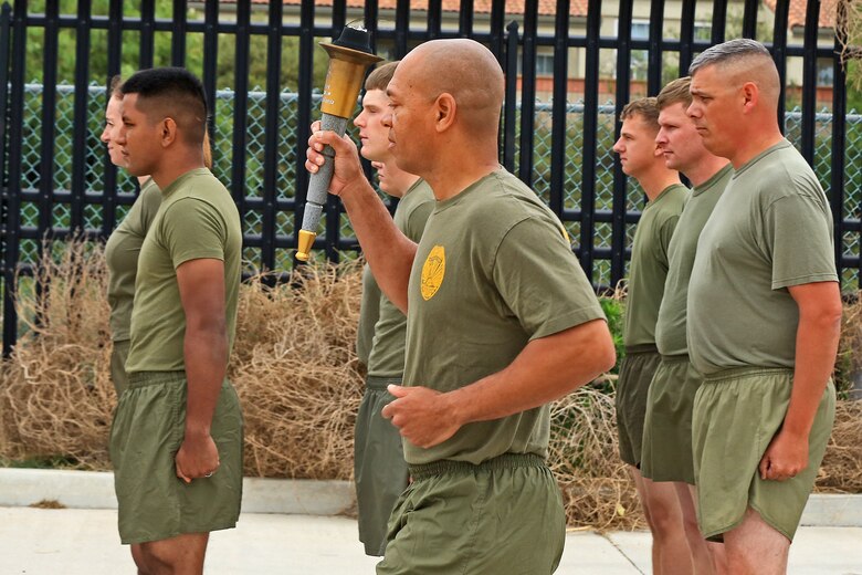 CAMP PENDLETON, Calif. -- Col. Reginald L. Hairston, commanding officer of SES Bn., Marine Corps Base Camp Pendleton, Marine Corps Installations – West, receives the Special Olympics torch from runners of the Oceanside Police Department at the Camp Pendleton Main Gate, June 1. More than 30 Marines and police officers from the Security and Emergency Service Battalion and the Camp Pendleton Police Department participated in the 2016 Law Enforcement Torch Run in support of the Special Olympics.