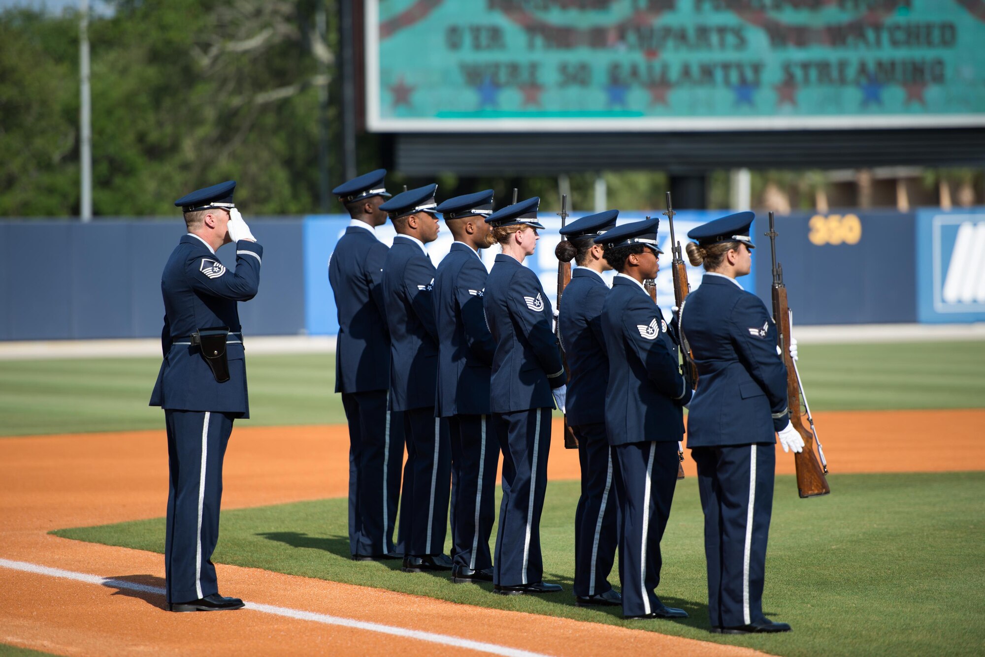 Members of the Keesler Honor Guard 3-volley rifle salute team stand at attention at MGM Park during the Biloxi Shuckers Minor League Baseball Military Appreciation Game May 29, 2016, Biloxi, Miss. Keesler children and leadership also attended the event honoring local military members. (U.S. Air Force photo by Marie Floyd)
