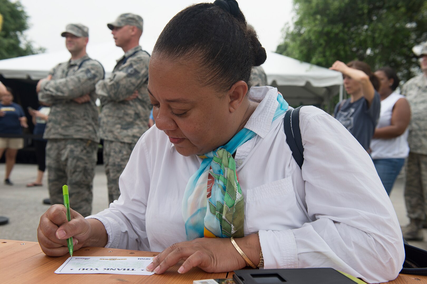 writes a letter to military members thanking them for their service during Sunny Anderson’s visit to Joint Base San Antonio-Lackland May 25. During the visit, Anderson, Food Network host and chef, signed autographs and gave free copies of her new book, “Sunny’s Kitchen,” to guests as part of a cross-country tour with Operation Gratitude, which has sent about 1.5 million care packages to service members.