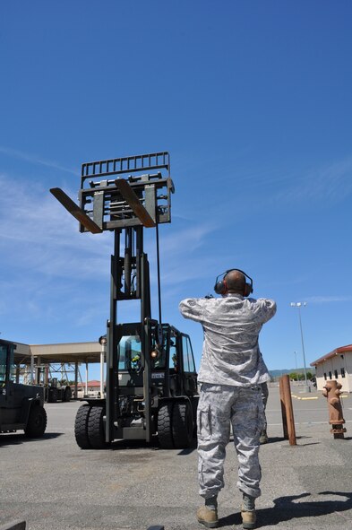 Airmen in the 55th Aerial Port Squadron ramp services complete the mission while also training up Airmen April 16, 2016 on the Travis Air Force Base flightline.  (U.S. Air Force photos/Staff Sgt. Madelyn Brown).