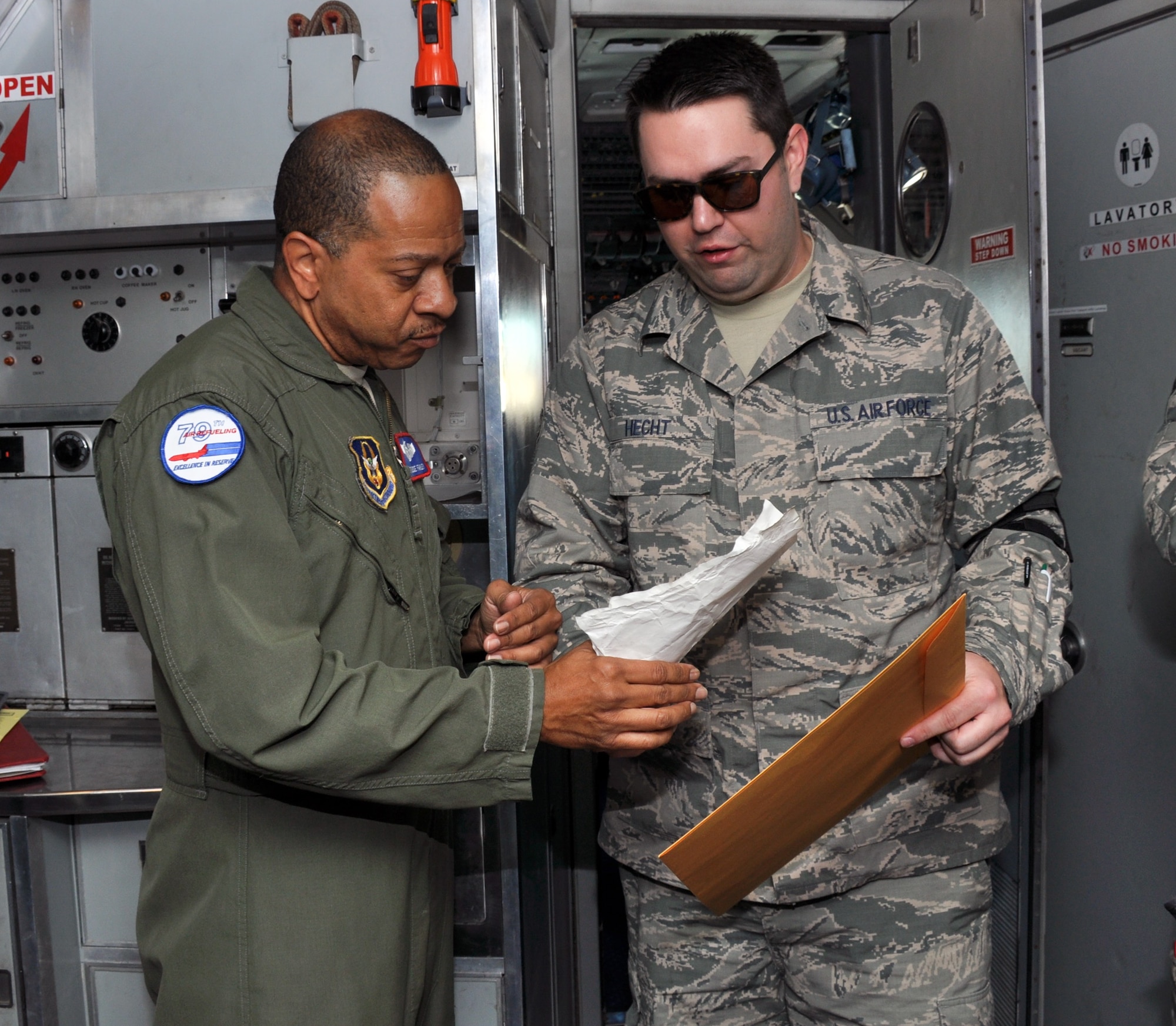 Senior Airman James Hecht, 55th Aerial Port Squadron air terminal operations center, briefs aircrew on the pertinent cargo information April 17, 2016, prior to loading the cargo onto the aircraft. (U.S. Air Force photo/Staff Sgt. Madelyn Brown)