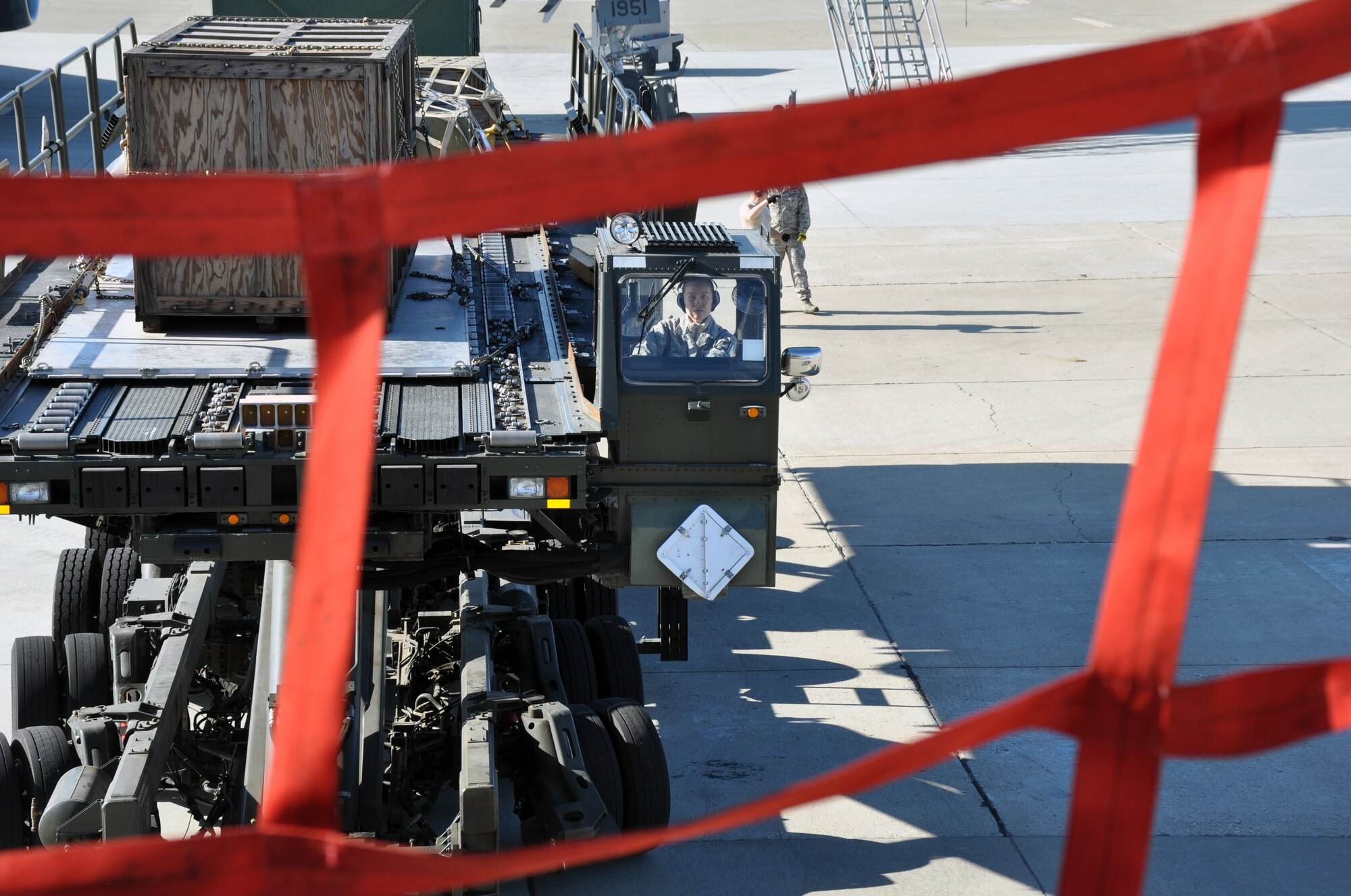Senior Airman Catherine Lubbe, 55th Aerial Port Squadron ramp services, trains by driving the Tunner 60k loader during a cargo load of a static KC-10 Extender April 17, 2016. (U.S. Air Force photo/Staff Sgt. Madelyn Brown)
