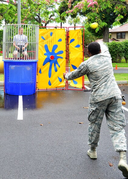 Senior Airman Debronis Warren, 15tth Medical Group, attempts to Dunk Master Sgt. Donald Prothero, from the 15th MDG, during the Second Annual Resiliency Festival hosted by the 15th Medical Group’s Mental Health Clinic on Joint Base Pearl Harbor-Hickam, May 26, 2016. The festival was held to raise awareness of mental health and the different aspects of human wellness. The event kicked off the 101 Critical Says of Summer safety campaign and ended May’s Mental Health awareness campaign. (U.S. Air Force photo by Tech. Sgt. Aaron Oelrich/Released)