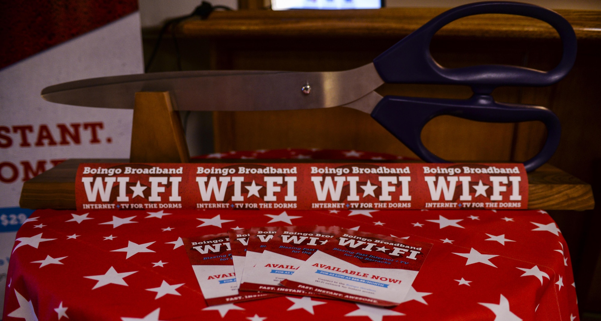 The Scissors used to cut the ceremonial ribbon sit before the Boingo “wire” cutting ceremony at Nellis
Air Force Base, Nev., May 31, 2016. Based to serve as a new option for dorm residents, Boingo wireless will go live on Nellis AFB May 26, 2016, and have multiple packages available for Airmen to choose from. (U.S. Air Force photo by Airman 1st Class Kevin Tanenbaum)
