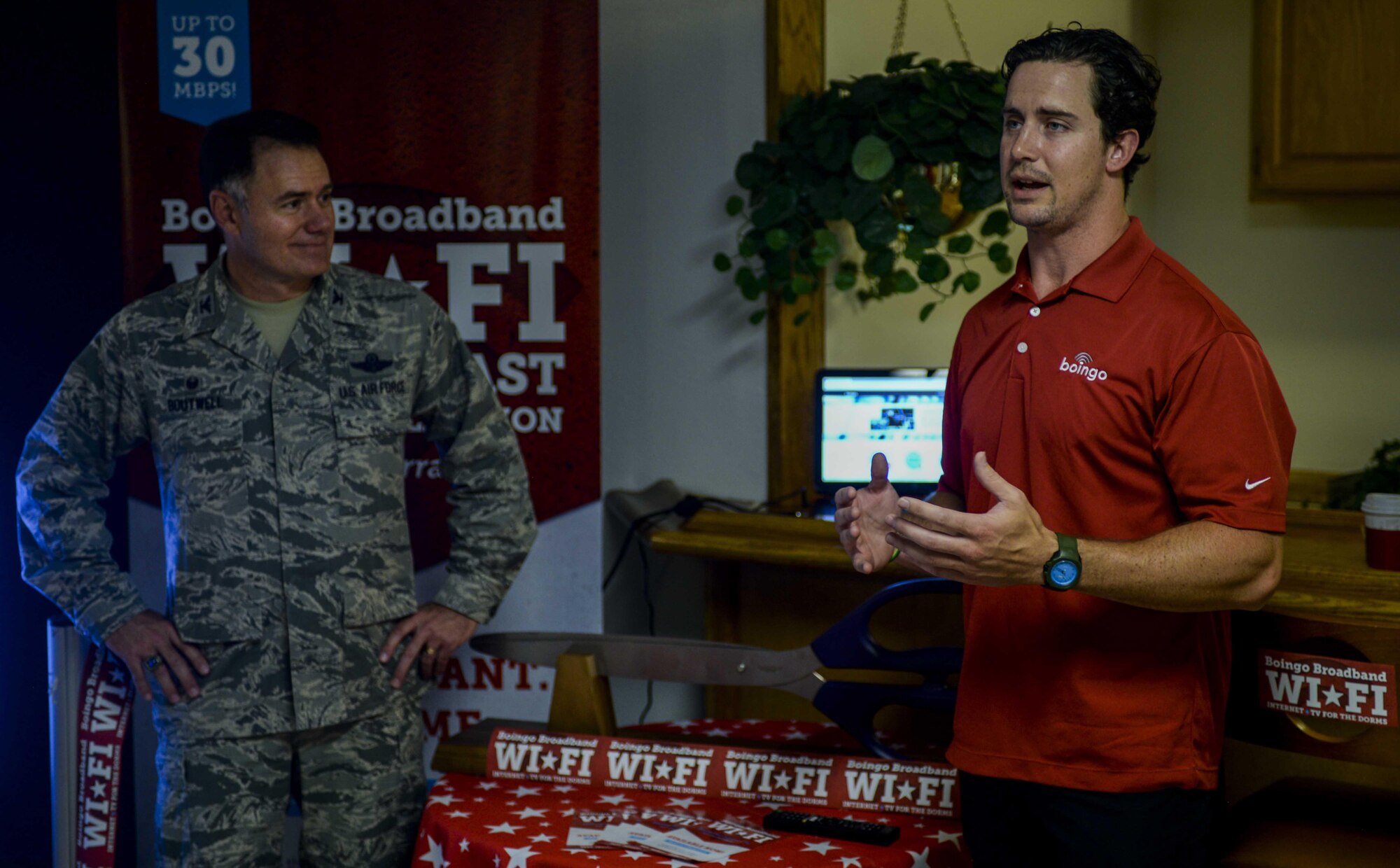 A Boingo Internet representative describes the different packages offered to Nellis AFB Airmen and Leadership during the “wire” cutting ceremony at Nellis Air Force Base, Nev., May 31, 2016. The new internet option not only requires no set up on the part of the dorm resident, but the flexible plan durations allow customers to select from day, week, to monthly recurring options with internet for different price points that will be accessible when signing up for the internet services. (U.S. Air Force photo by Airman 1st Class Kevin Tanenbaum)
