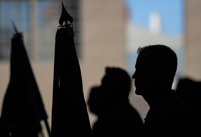 CMSgt. Clark Elliott, 57th MXS Munitions Flight Chief, holds a guidon during the change of command ceremony in Lightning Aircraft Maintenance Unit hangar at Nellis Air Force Base, Nev., May 26, 2016. Col. Rose stated that what he is most proud of is how we focused on issues within the Groups control and paid little attention to naysayers. (U.S. Air Force photo by Airman 1st Class Kevin Tanenbaum)