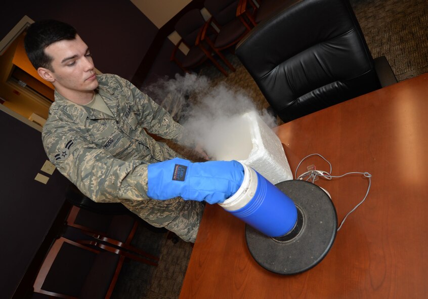 Airman 1st Class Cody Moss, 2nd Aerospace Medicine Squadron public health technician, prepares a mosquito trap for setup at Barksdale Air Force Base, La., May 31, 2016. Dry ice was placed in the trap to mimic carbon dioxide emitted by humans and anima. By using dry ice, technicians raise the effectiveness of the trap and increase collected specimen numbers for study. (U.S. Air Force photo/Senior Airman Mozer O. Da Cunha)
