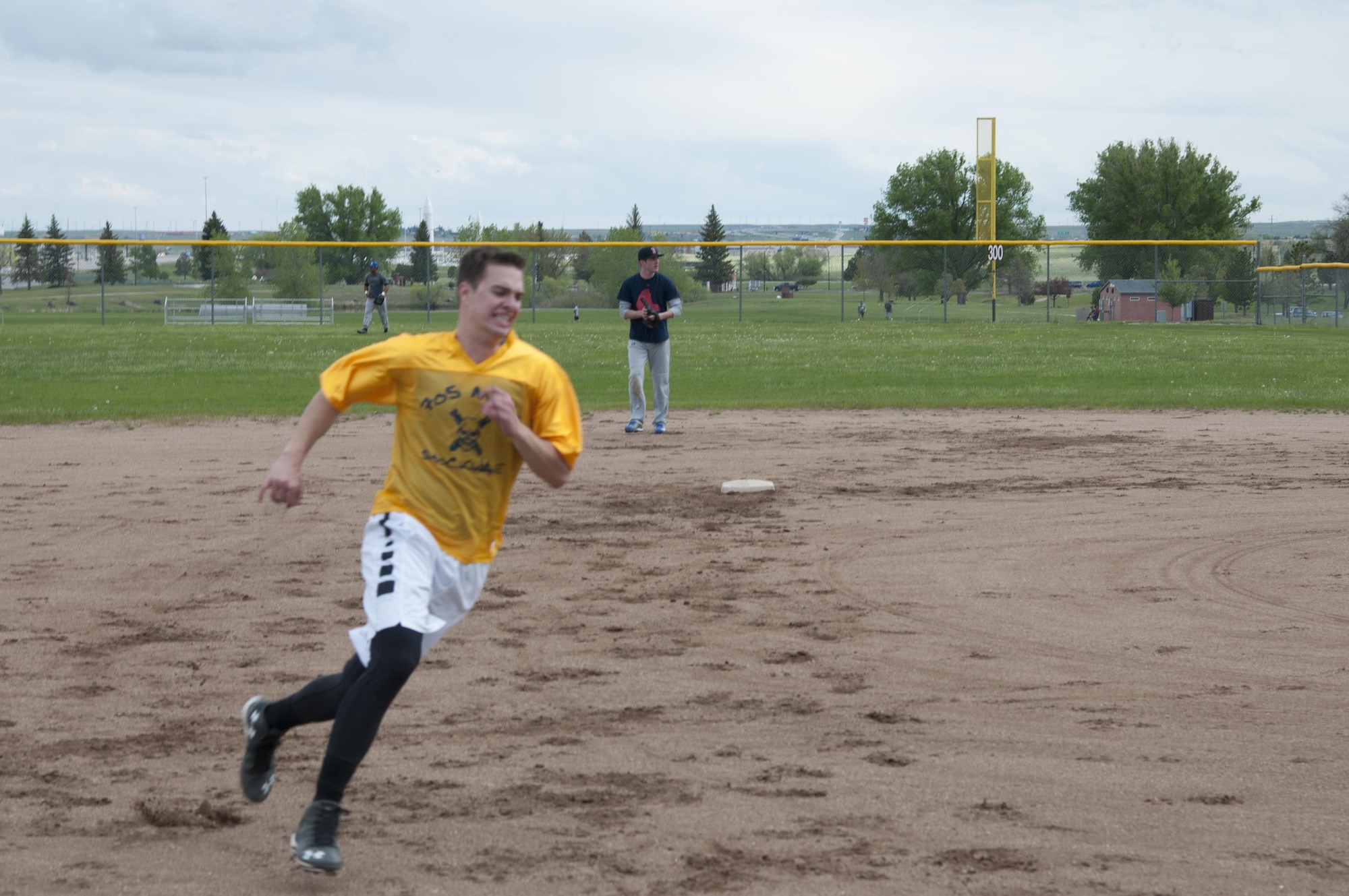 Cameron Perkins, 90th Munitions Squadron intramural softball team player, rounds third on his way to the home plate May 31, 2016, on one of the F.E. Warren Air Force Base, Wyo., ball fields. Perkins made one of the 21 runs of the game for his team, clinching victory against the 790th Missile Security Forces Squadron's 9 points in the game. (U.S. Air Force photo by Senior Airman Jason Wiese)