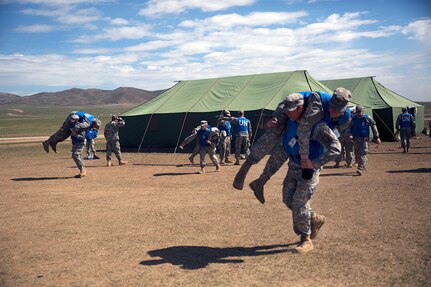 U.S. Soldiers with the Alaska Army National Guard practice patient transportation techniques during the combat medical care training lane of Khaan Quest 2016 at Five Hills Training Area near Ulaanbaatar, Mongolia, May 30. The training equipped soldiers with essential life-saving skills and the ability to prioritize injuries and medical care. Khaan Quest 2016 is an annual, multinational peacekeeping operations exercise hosted by the Mongolian Armed Forces, co-sponsored by U.S. Pacific Command, and supported by U.S. Army Pacific and U.S. Marine Corps Forces, Pacific. Khaan Quest, in its 14th iteration, is the capstone exercise for this year’s Global Peace Operations Initiative program. The exercise focuses on training activities to enhance international interoperability, develop peacekeeping capabilities, build to mil-to-mil relationships, and enhance military readiness.