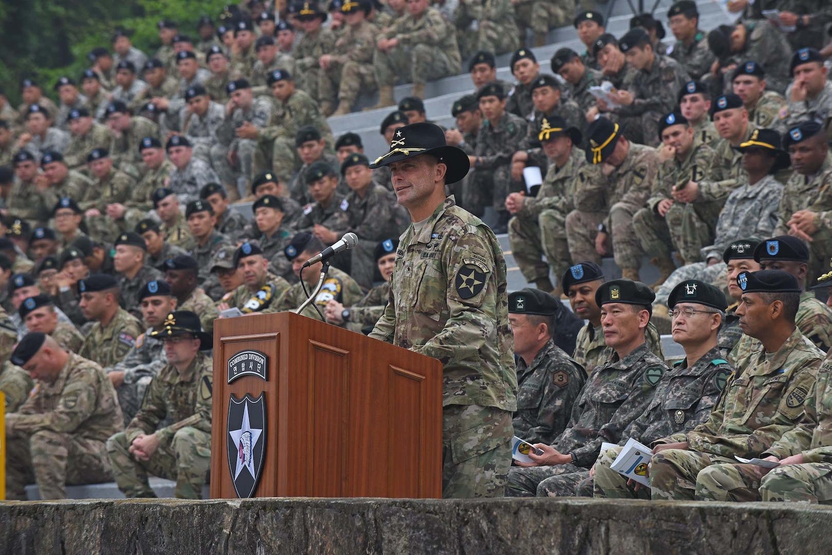 Brig. Gen. Brian Mennes, deputy commanding general for maneuver, 2nd Infantry Division, discusses the importance of the Expert Infantryman Badge and congratulates the U.S. and South Korean Soldiers that earned the badge, during a ceremony May 26 at the Schoonover Bowl, Camp Casey, South Korea. (U.S. Army photo by Staff Sgt. Keith Anderson, 1st Armored Brigade Combat Team Public Affairs, 1st Cav. Div.)