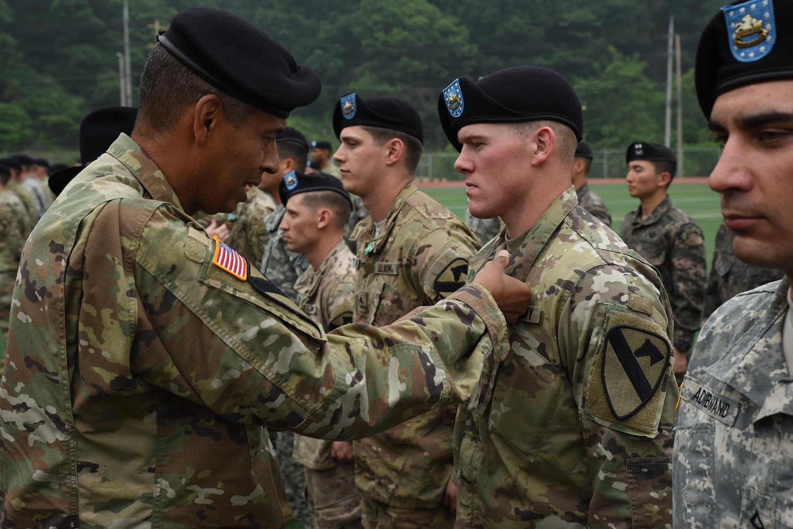 Gen. Vincent Brooks, commanding general, USFK, pins a U.S. Army Commendation Medal on Sgt. Andrew Raines, Company A, 2nd Battalion, 8th Cavalry Regiment, 1st Armored Brigade Combat Team, 1st Cavalry Division, for successfully completing every event without retest and receiving first time “go’s” on every evaluation to earn the Expert Infantryman Badge, a “True Blue” awardee. 131 U.S. and South Korean Soldiers earned the Expert Infantryman Badge, with 29 achieving “True Blue” status, during a ceremony May 26 at Camp Casey, South Korea. (U.S. Army photo by Staff Sgt. Keith Anderson, 1st Armored Brigade Combat Team Public Affairs, 1st Cav. Div.)