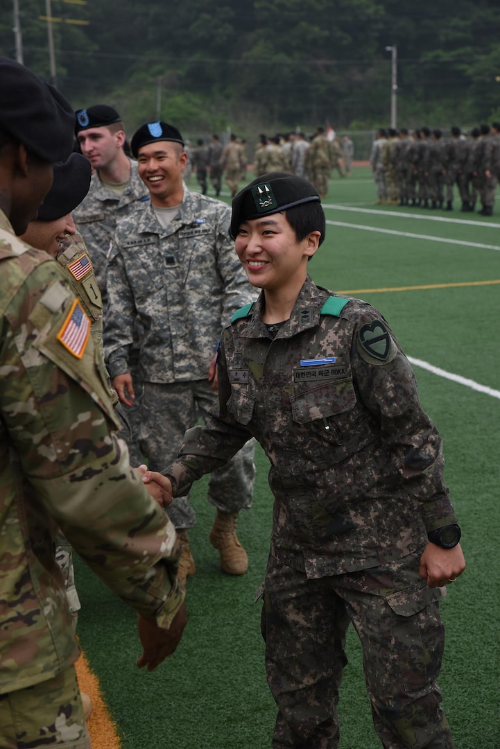 Soldiers congratulate Republic of Korea Army 1st Lt. Ji Eun Jeong, a platoon leader in the 115th Mechanized Infantry Battalion, 90th Mech. Inf. Brigade, 30th Mech. Inf. Division, on earning an U.S. Army Expert Infantryman Badge. Jeong, a 25-year-old from Seoul, South Korea, is the first female ROK officer to complete the EIB. South Korean officers are not actually authorized to wear the U.S. badge, but were pinned during the ceremony and awarded a certificate of achievement. (U.S. Army photo by Staff Sgt. Keith Anderson, 1st Armored Brigade Combat Team Public Affairs, 1st Cav. Div.)