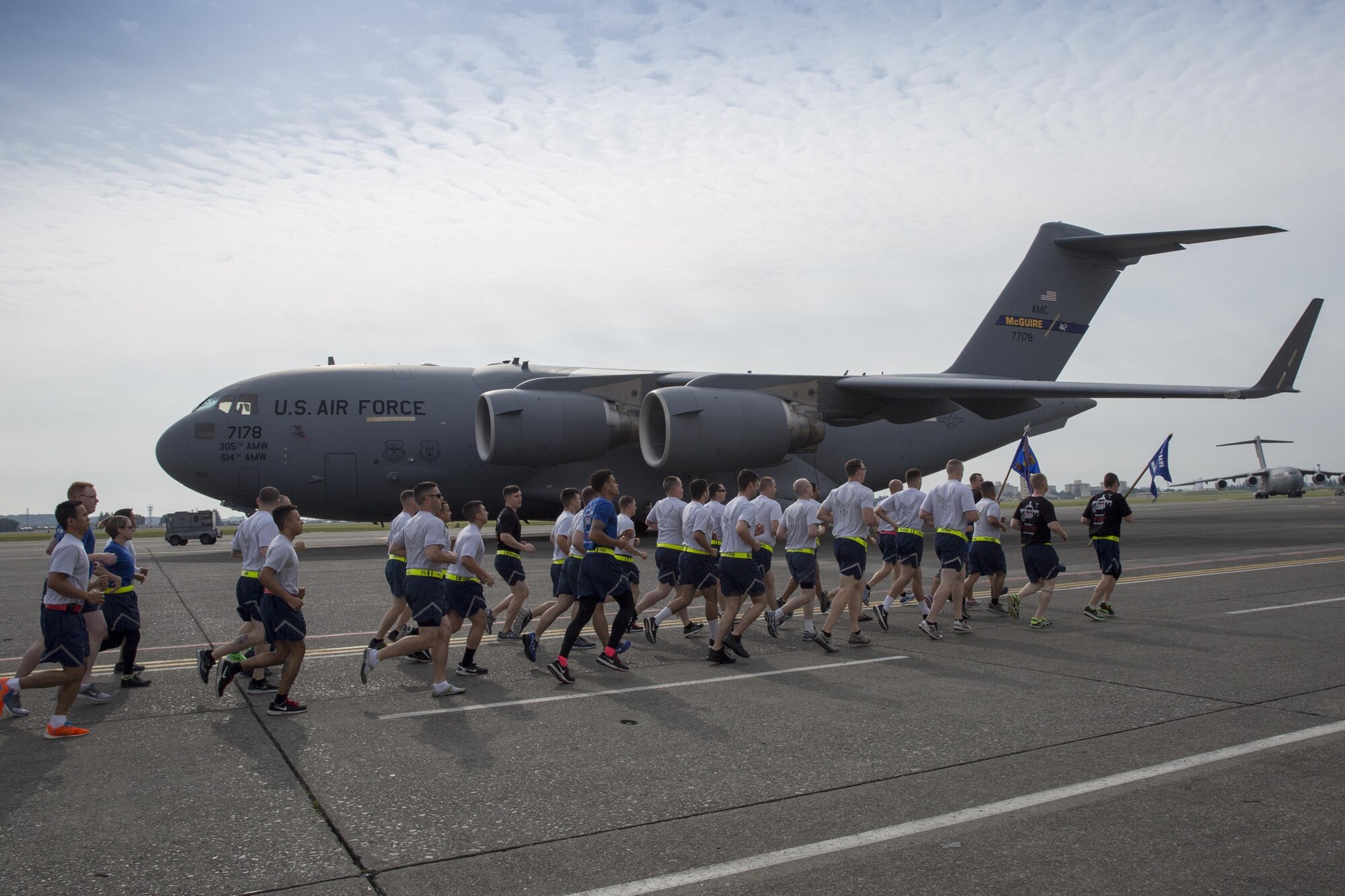 Yokota Airmen with the 515th Air Mobility Operations Group, 730th Air Mobility Command, and 374th Logistics Readiness Squadron run in a formation during the Port Dawg Memorial 5K Run at Yokota Air Base, Japan, May 20, 2016. “Port Dawg” is a nickname for aerial port members. This is the 3rd annual memorial run for the fallen Airmen in the air transportation career field from the past. (U.S. Air Force photo by Yasuo Osakabe/Released) 