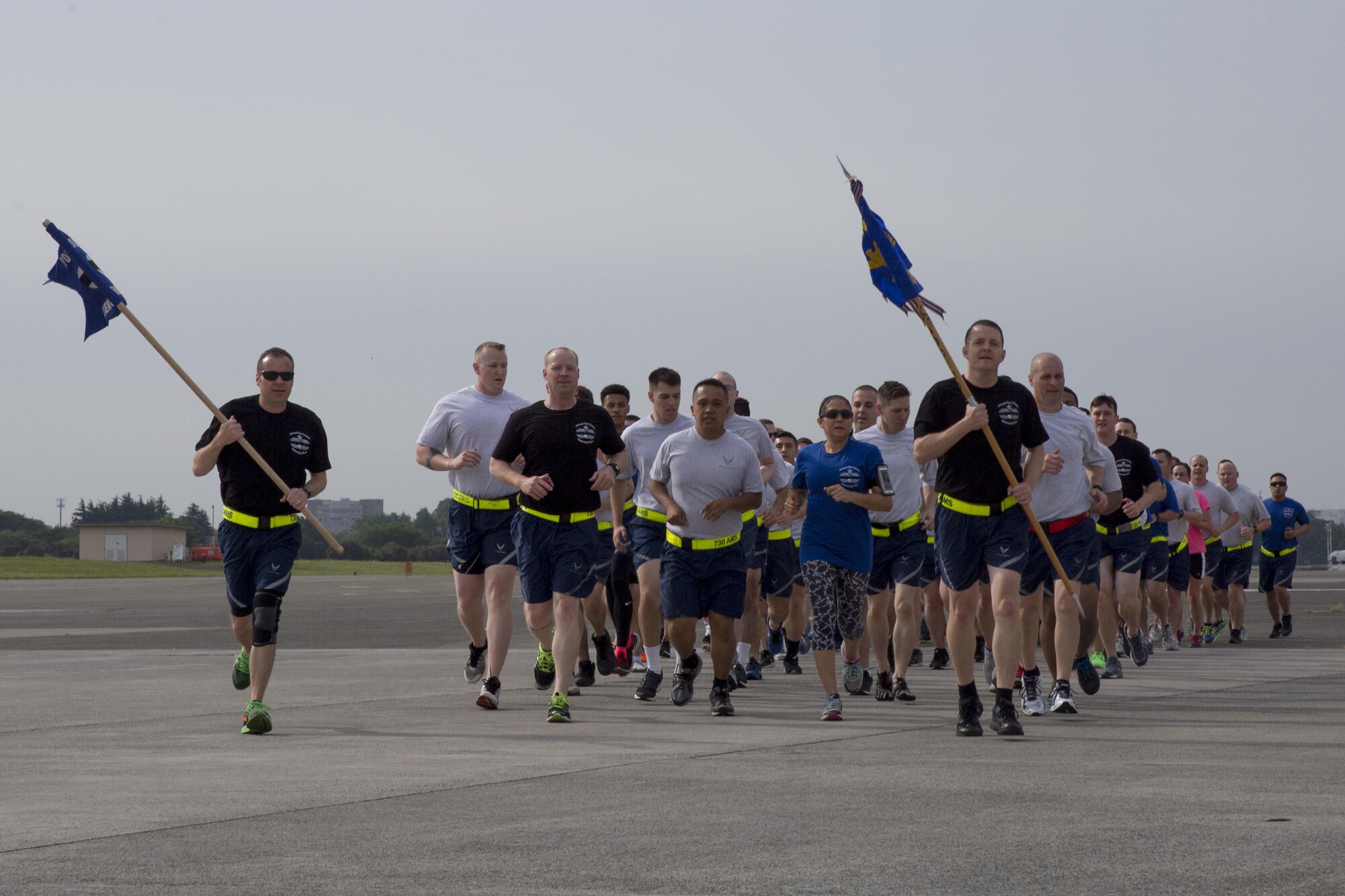 Yokota Airmen from the 515th Air Mobility Operations Group, 730th Air Mobility Squadron, and 374th Logistics Readiness Squadron run in a formation during the Port Dawg Memorial 5K Run at Yokota Air Base, Japan, May 20, 2016. The 730 AMS hosted the annual memorial run for the fallen Airmen in the air transportation career field from the past. (U.S. Air Force photo by Yasuo Osakabe/Released) 