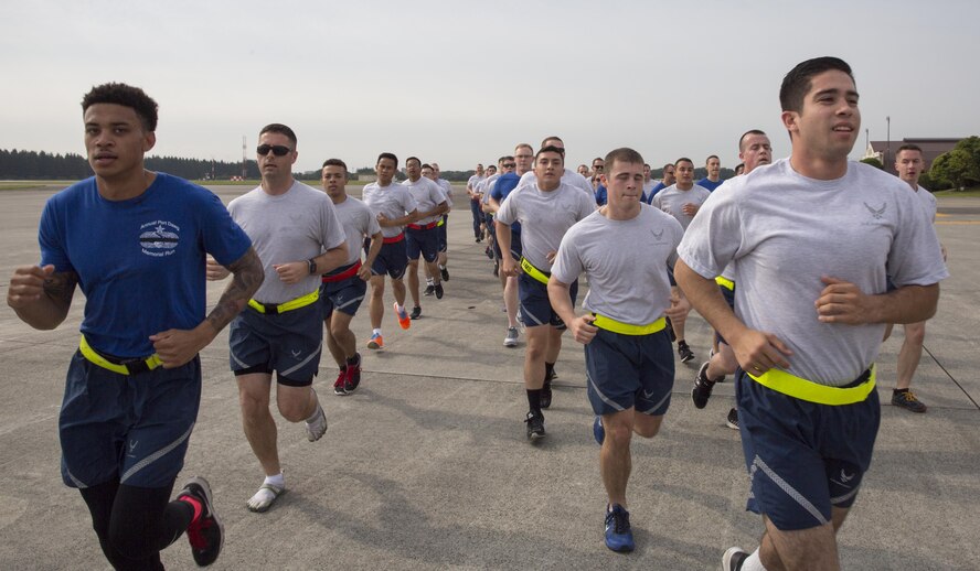 Airmen with the 730th Air Mobility Squadron and 374th Logistics Readiness Squadron run in a formation during the Port Dawg Memorial 5K Run at Yokota Air Base, Japan, May 20, 2016. The 730 AMS hosted the annual memorial run for the fallen Airmen in the air transportation career field from the past. (U.S. Air Force photo by Yasuo Osakabe/Released) 