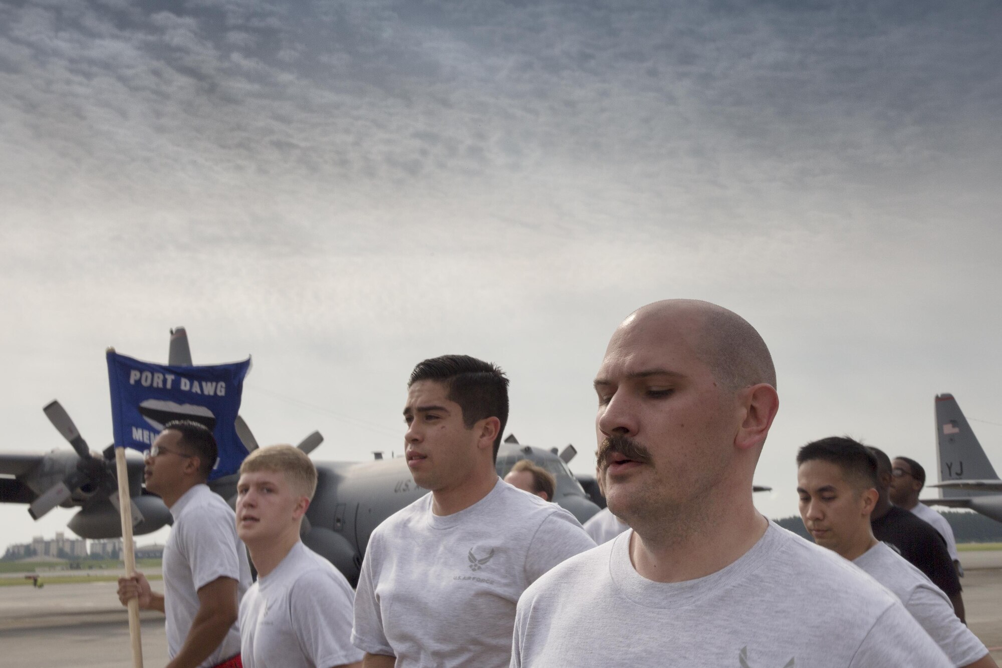Airmen with the 730th Air Mobility Squadron and 374th Logistics Readiness Squadron run in a formation during the Port Dawg Memorial 5K Run at Yokota Air Base, Japan, May 20, 2016. The 730 AMS hosted the annual memorial run for the fallen Airmen in the air transportation career field from the past. (U.S. Air Force photo by Yasuo Osakabe/Released) 