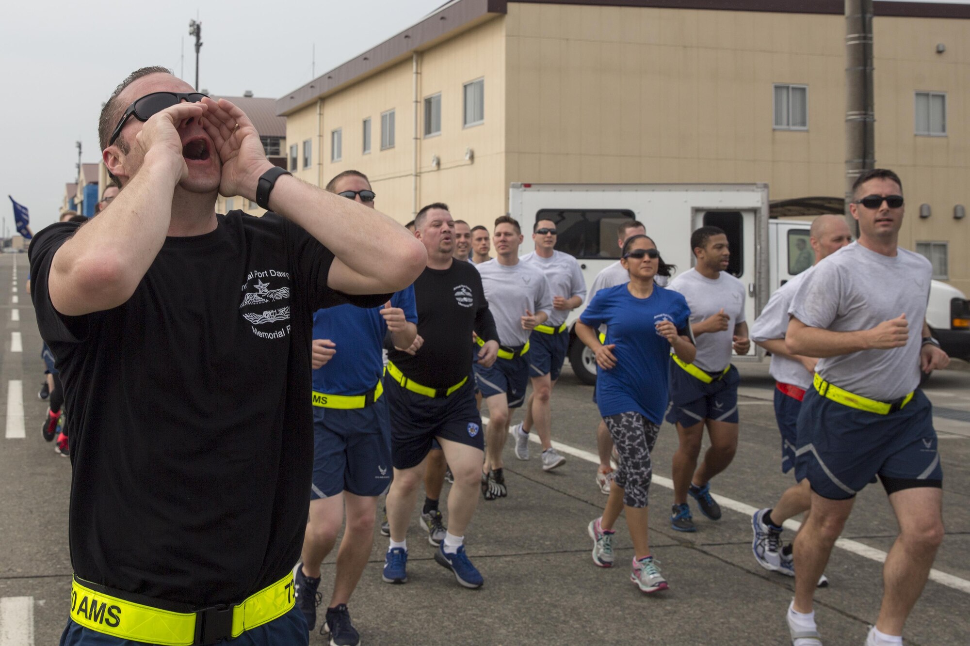 Senior Master Sgt. Cameron Davis, 730th Air Mobility Squadron aerial port superintendent, leads the squadron cheer during the Port Dawg Memorial 5K Run at Yokota Air Base, Japan, May 20, 2016. The 730 AMS hosted the annual memorial run for the fallen Airmen in the air transportation career field from the past. (U.S. Air Force photo by Yasuo Osakabe/Released) 