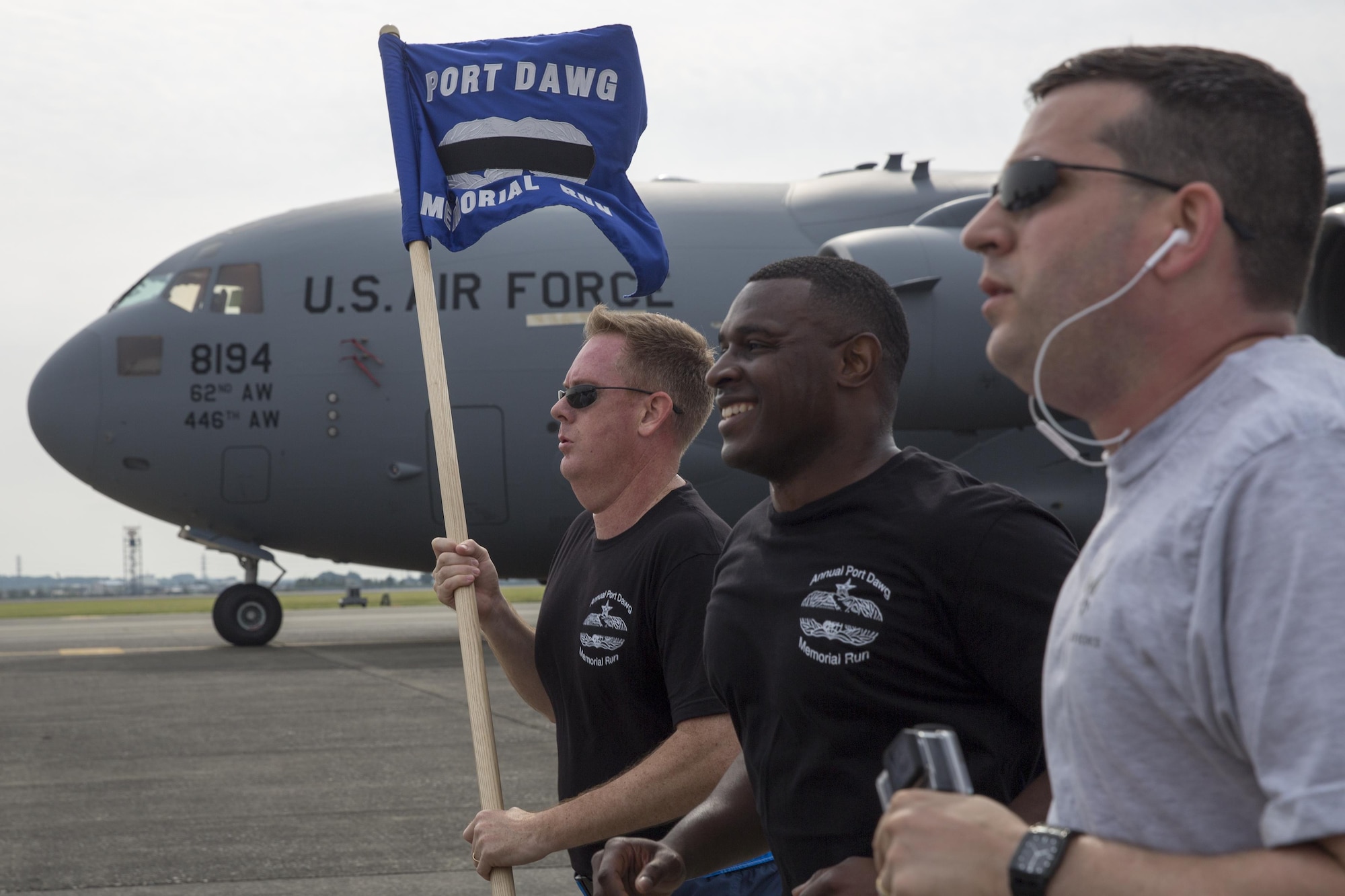 Col. Dale Landis, left, 515th Air Mobility Operations Group commander, holds the guidon during the Port Dawg Memorial 5K Run at Yokota Air Base, Japan, May 20, 2016. The 730th Air Mobility Squadron hosted the annual memorial run for the fallen Airmen in the air transportation career field from the past. (U.S. Air Force photo by Yasuo Osakabe/Released) 