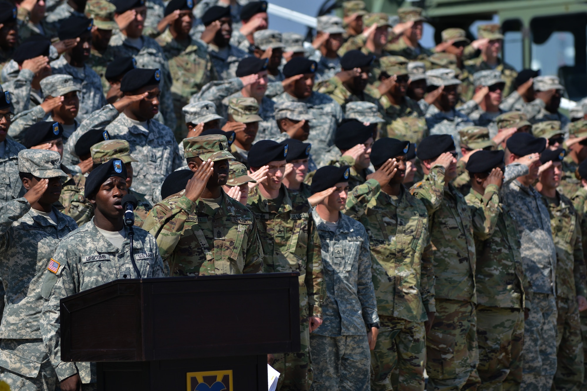 Members of the 7th Transportation Brigade (Expeditionary) salute as the National Anthem is performed during the brigade’s change of responsibility ceremony at Fort Eustis, Va., May 26, 2016. The brigade works out of Fort Eustis, Va., and Joint Expeditionary Base, Little Creek, Va. to provide logistic support around the world. (U. S. Air Force photo by Staff Sgt. Natasha Stannard)