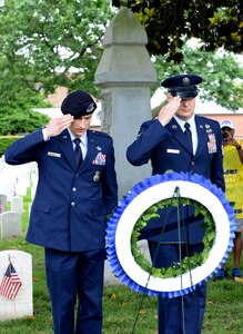 U.S. Air Force 2nd Lt. Sean Grabowski, officer-in-charge of police services assigned to the 633rd Security Forces Squadron, and Master Sgt. Richard Chwalik, first sergeant assigned to the 633rd SFS, salute a ceremonial wreath during a Memorial Day ceremony in Hampton, Va., May 30, 2016. During the ceremony, U.S. military personnel and local community members honored the fallen, prisoners of war and those missing in action who have served in conflicts across the world. (U.S. Air Force photo by Staff Sgt. Teresa J. Cleveland)
