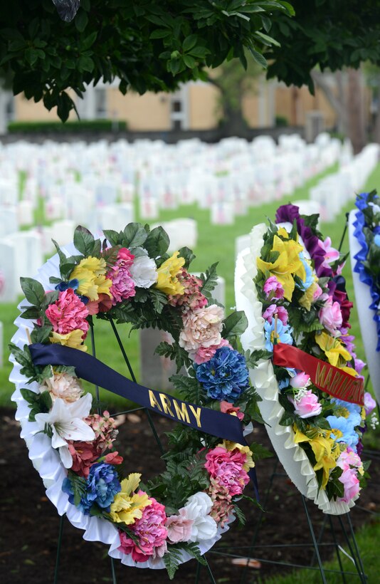 Wreaths are displayed near headstones of fallen Service members at the Hampton National Cemetery during a Memorial Day Ceremony in Hampton, Va., May 30, 2016. In addition to the wreaths, flags were placed at each gravesite to honor those who paid the ultimate price for freedom of the United States and its allies. (U.S. Air Force photo by Staff Sgt. Teresa J. Cleveland)