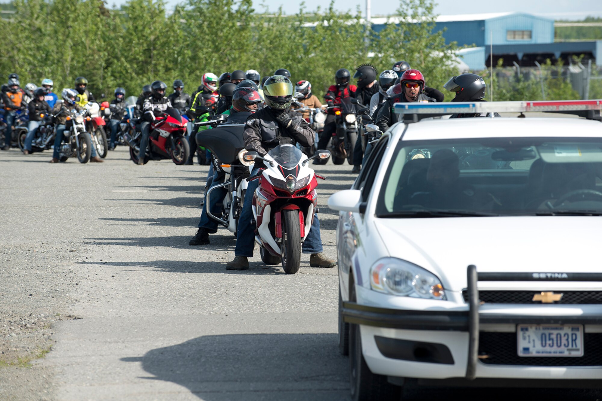 673d Security Forces provide a police escort to riders at the motorcycle safety pad on JBER-Richardson, May 26. The Joint Base Elmendorf-Richardson annual motorcycle safety ride is designed to connect new riders with experienced riders to foster mentor relationships and hone their skills together. (U.S. Air Force photo by Senior Airman Kyle Johnson)