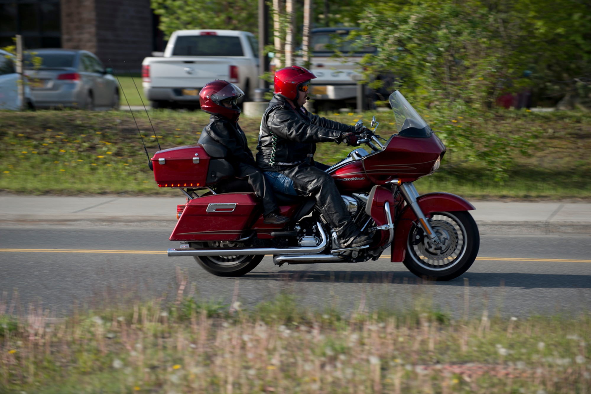 Fort Wainwright firefighter Heath Melvin and his son A.J. arrive at the motorcycle safety pad on JBER-Richardson, May 26. The Joint Base Elmendorf-Richardson annual motorcycle safety ride is designed to connect new riders with experienced riders to foster mentor relationships and hone their skills together. (U.S. Air Force photo by Senior Airman Kyle Johnson)