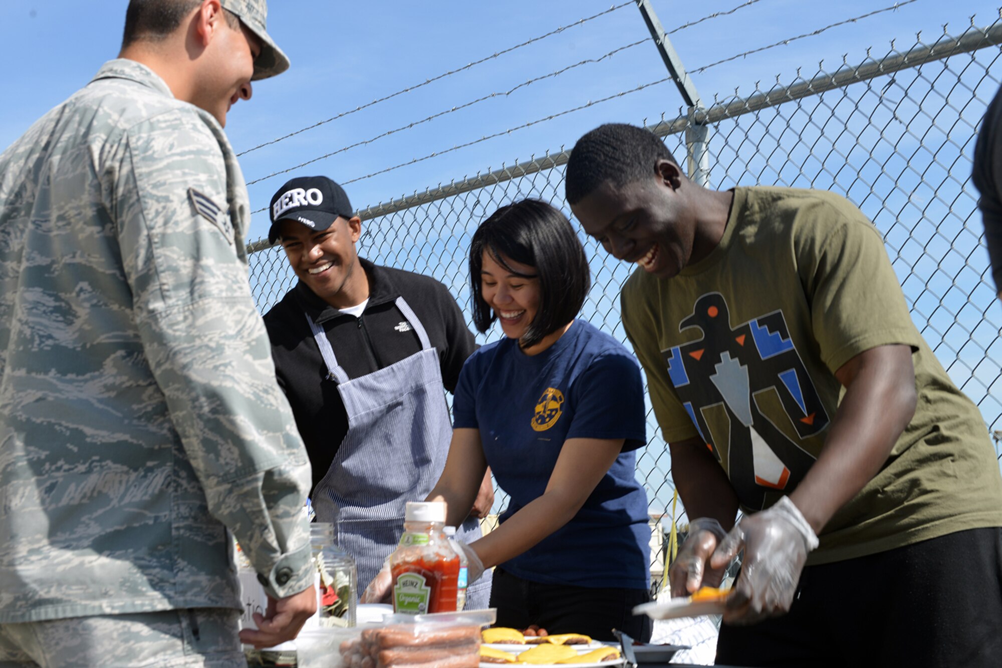 Airmen grill hotdogs and burgers at the safety fair on joint base Elmendorf Richardson, Alaska, May 26, 2016. The JBER occupational safety office hosted the event to raise awareness of the safety resources available on the installation. (U.S. Air Force photo by Airman 1st Class Javier Alvarez)
