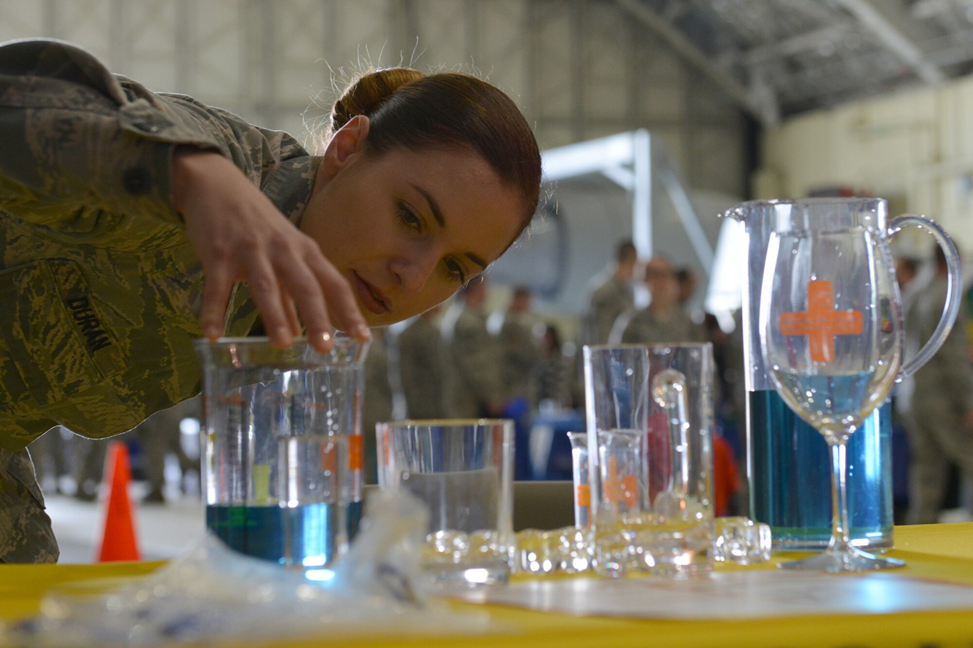 Senior Airman Jessica Duran, 673d Medical Operations Squadron mental health technician, gives a demonstration on alcohol consumption at the safety fair on joint base Elmendorf-Richardson, Alaska, May 26, 2016.  ADAPT and the Army Substance Abuse Program are the substance abuse, prevention and treatment programs available on JBER. (U.S. Air Force photo by Airman 1st Class Javier Alvarez)