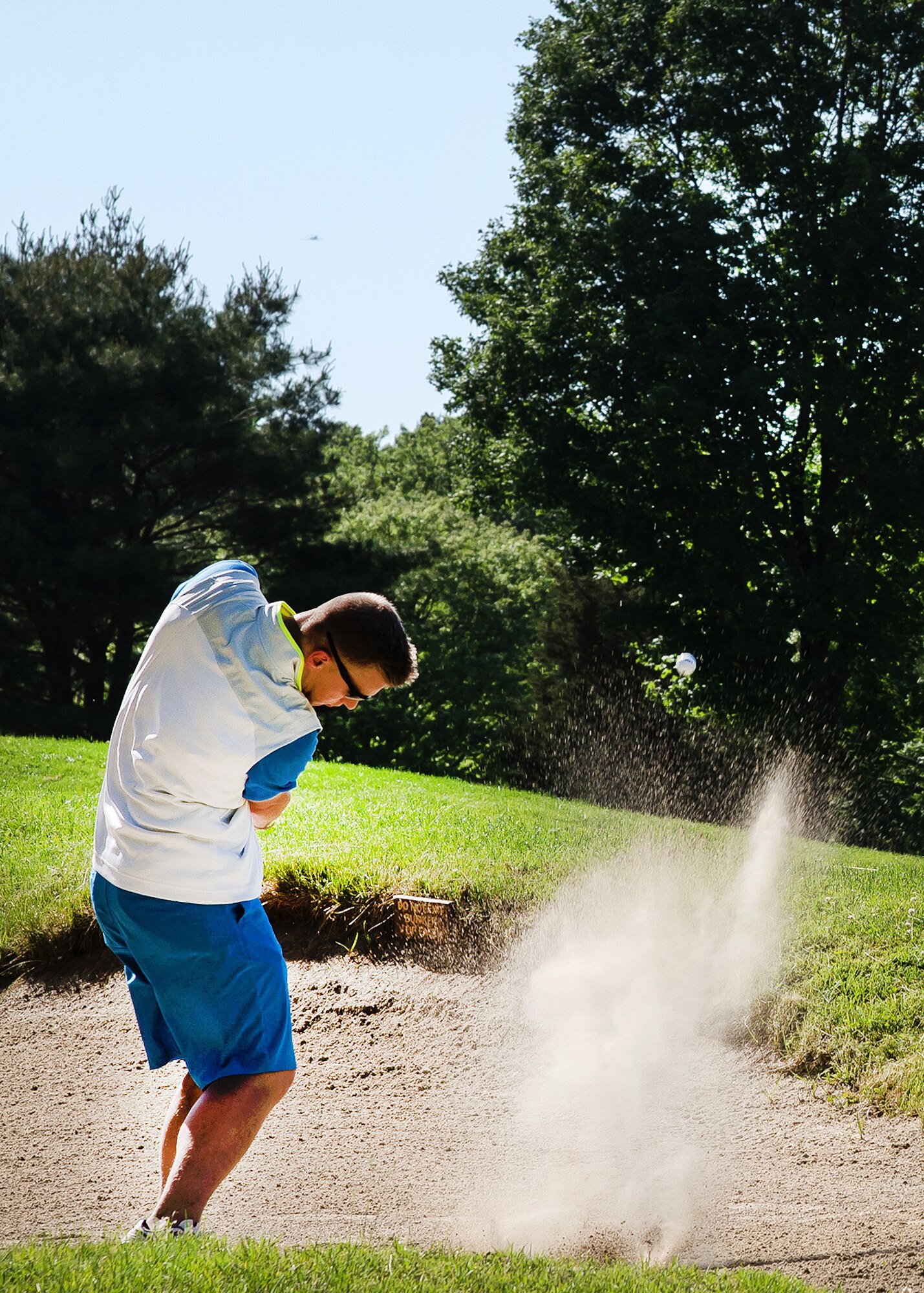 Senior Airman Randy A. Hodgson, Jr., 66th Air Base Group knowledge operations specialist, hits a shot at the Patriot Golf Course during an intramural golf league match May 31. Hanscom's Patriot Golf Course is on the grounds of the Veterans Administration Medical Center in Bedford, Mass., and a nine-hole regulation golf course with driving range, practice putting and chipping greens, a full-service Pro Shop and snack bar. (U.S. Air Force photo by Walter Santos)