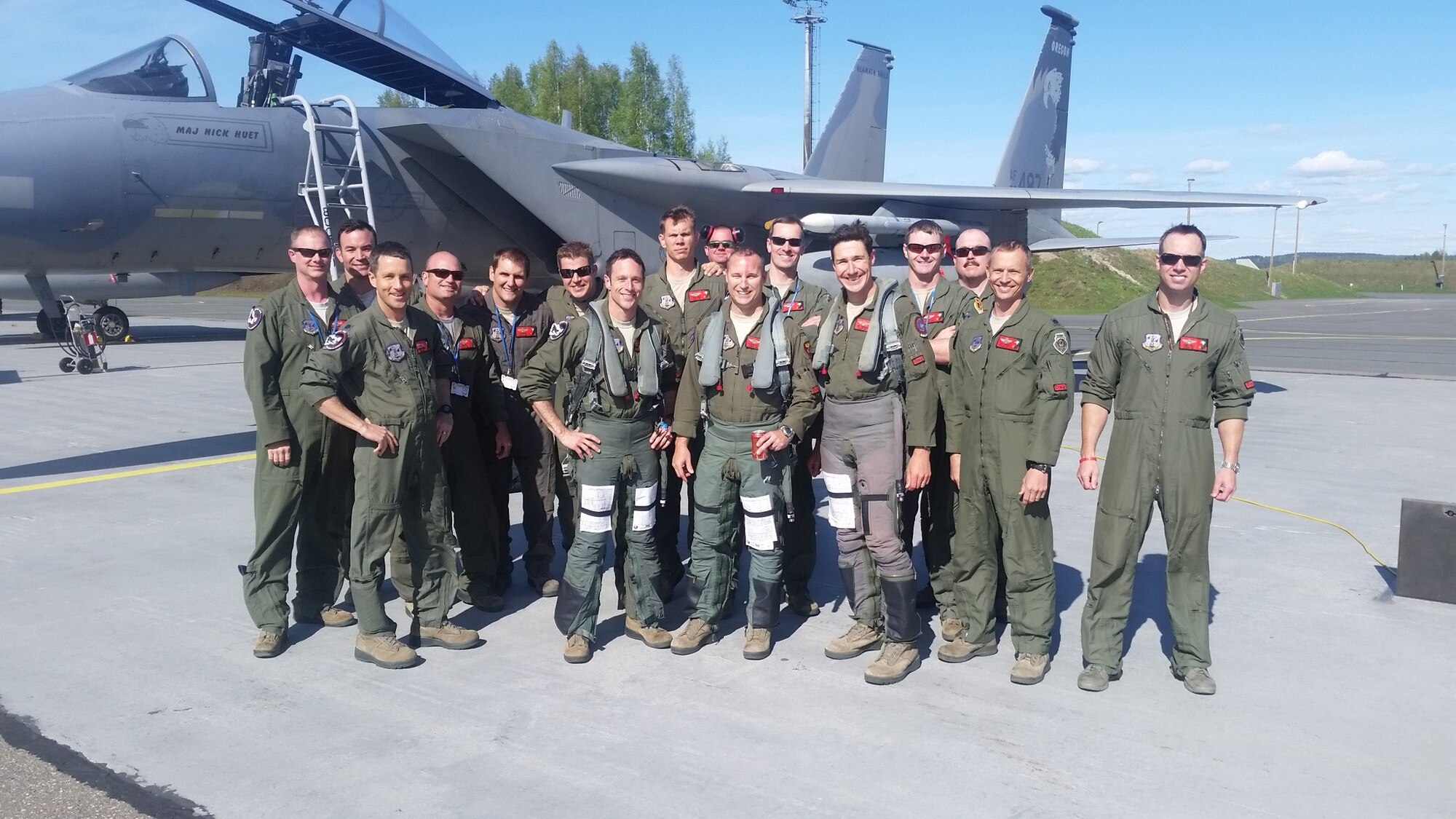 U.S. Air Force Maj. Michael Hiatt (center), an instructor pilot at the 173rd Fighter Wing in Klamath Falls, Ore., stands with his fellow pilots immediately after crossing the 2,000 hour mark in the F-15 Eagle while deployed to Kuopio, Finland, May 10, 2016. The wing conducted training operations with partner nation Finland over two weeks in early May as part of Operation Atlantic Resolve. (U.S. Air National Guard photo by Senior Master Sgt. Pete Weigman)