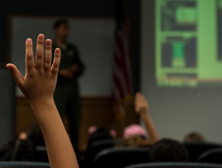 First grade students from Bechtel Elementary School ask questions during a mission briefing from the 44th Fighter Squadron May 16, 2016, at Kadena Air Base, Japan. Students were given the opportunity to ask questions about the F-15 Eagle, the 44th FS and the life of a pilot. (U.S. Air Force photo by Airman 1st Class Lynette M. Rolen)