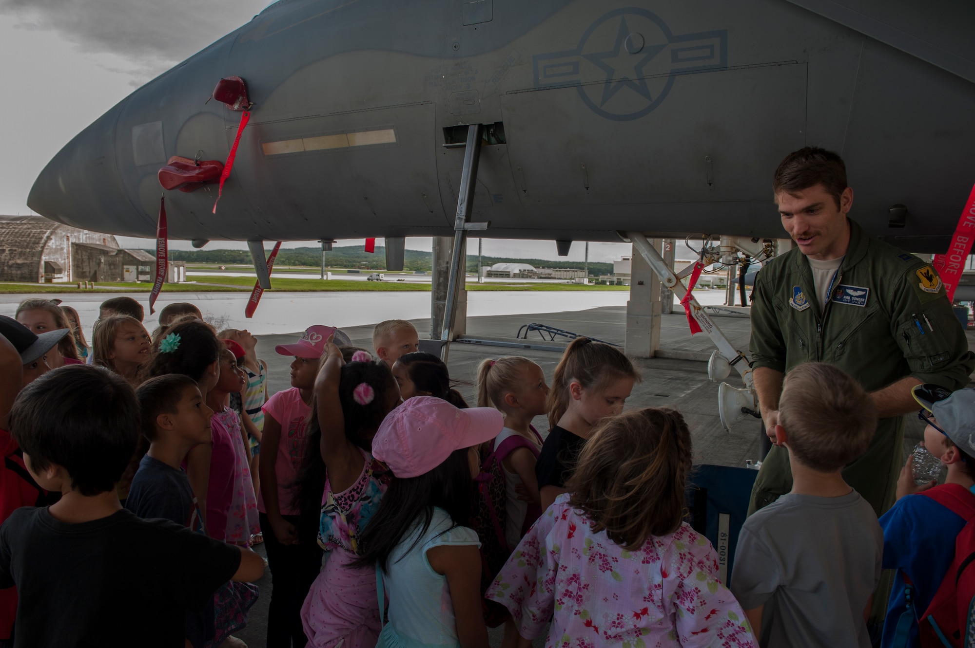 U.S. Air Force Capt. Joseph Songer, 44th Fighter Squadron pilot, talks to first grade students from Bechtel Elementary School May 16, 2016, at Kadena Air Base, Japan. Songer spoke to the students and answered questions about the different specifications of the F-15 Eagle and how it provides premier air power. (U.S. Air Force photo by Airman 1st Class Lynette M. Rolen)