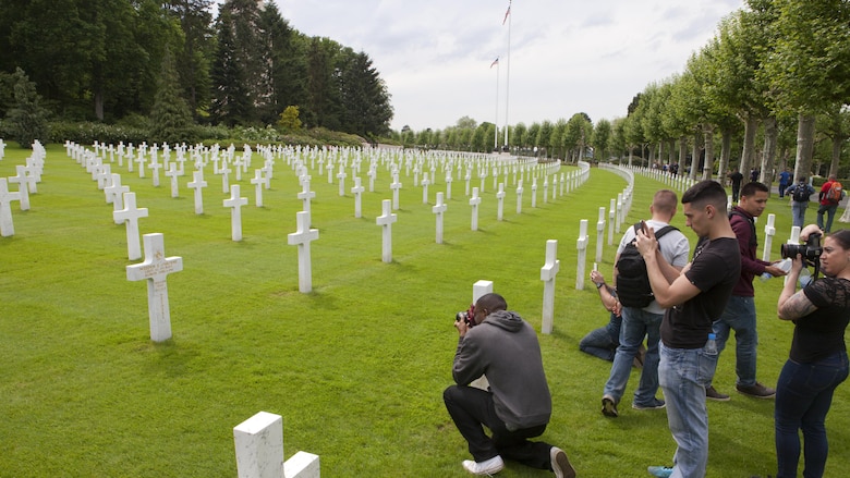 Marines from Headquarters and Service Battalion, Headquarters Marine Corps, Henderson Hall and Marine Barracks Washington, D.C., take photos of the grave marker for Lt. j.g. Weedon Osborne the only Medal of Honor recipient interred at Aisne-Marne American Cemetery in Belleau, France, May 26, 2016. Osborne was a dentist who served as corpsman for the 6th Marine Regiment and was killed in action trying to carry an injured Marine to safety June 6, 1918. 