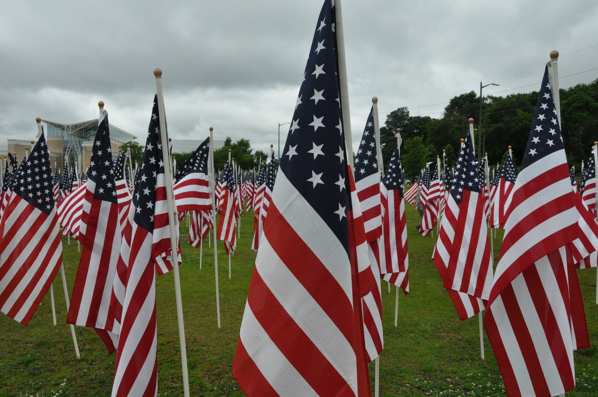 Hundreds of flags fly gallantly in the Airborne and Special Operations’ Field of Honor in recognition of all service members who made the ultimate sacrifice in their service to our country, May 21, 2016. This year’s Field of Honor dedication to our fallen heroes since 9/11, mirrors nearly 300 fields across the United States. It is the hope that the sea of flags in front of the ASOM engenders hope, comfort and healing, by providing a positive image of patriotism for the community of Fayetteville as well as acknowledgment of scale of sacrifice each flag represents.  (Air Force photo by Allison Janssen)