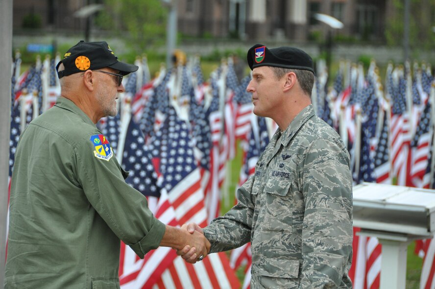 Colonel Christopher Jensen, Commander 18th Air Support Operations Group, Air Combat Command, speaks with veteran after the conclusion of this year’s 9th annual Field of Honor Ceremony, May 21, 2016. The Field of Honor displays hundreds of flags in recognition of the ultimate sacrifice military members have paid in duty and service to our country. This sacred field pays tribute to their stories of service, honor and heroism. (Air Force photo by Allison Janssen)